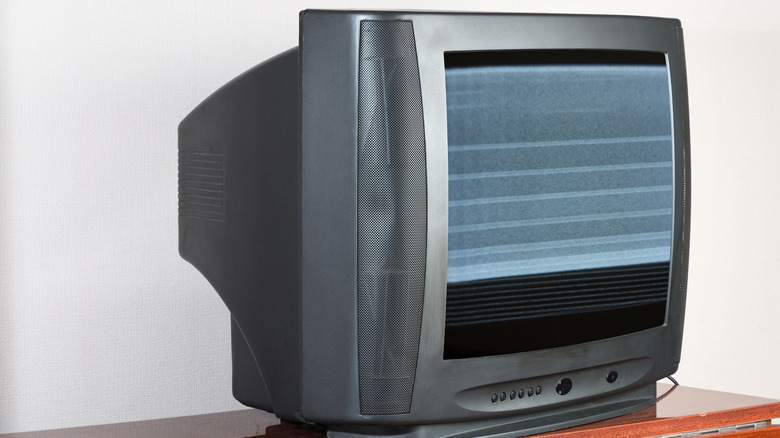 An old CRT TV with static on the display.