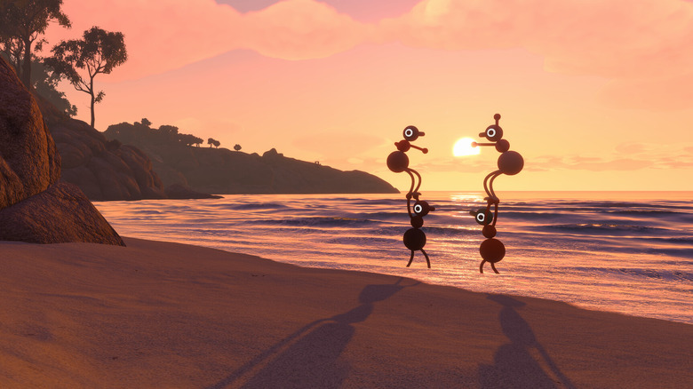 Abstract figures stand on each other's hands on a beach at sunset.
