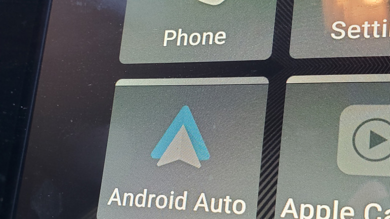 An enlarged Android Auto button on a car dashboard