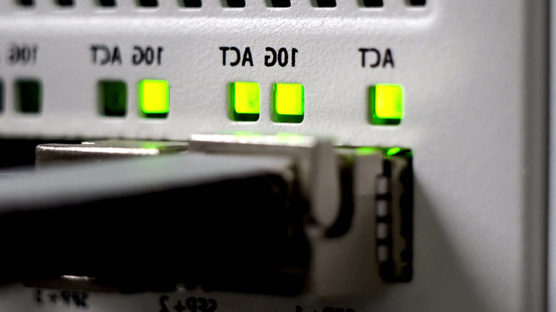 Network cable connected to a port with green activity lights.