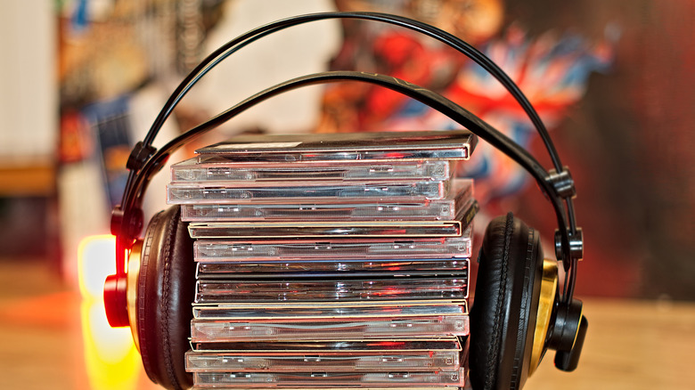 A stack of CDs with headphones