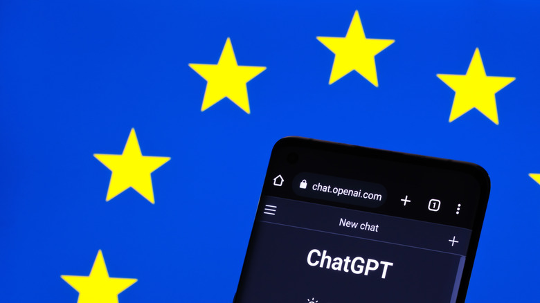 Smartphone with ChatGPT open in front of the European Union flag