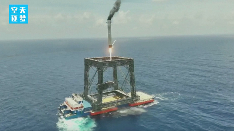 A frame grab from a video showing China's Long March 10B rocket booster landing in a net.