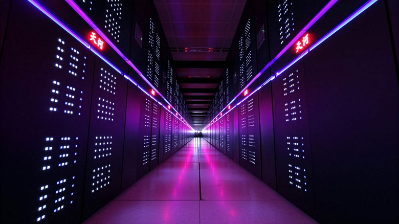 A long line of servers illuminated with purple lighting and marked with chinese characters at China's Supercomputing Center