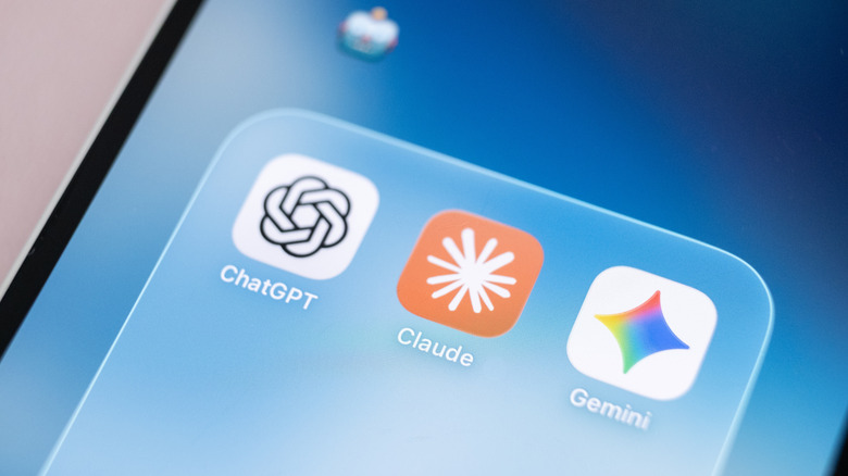 The icons for ChatGPT, Claude and Gemini sit in an iOS folder with the robot emoji above.