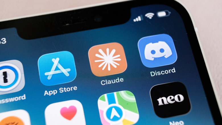A closeup of the Claude icon on the home screen of an iPhone 12.