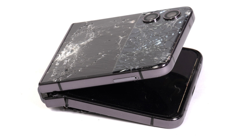 Shattered exterior screen and broken interior of a foldable phone.