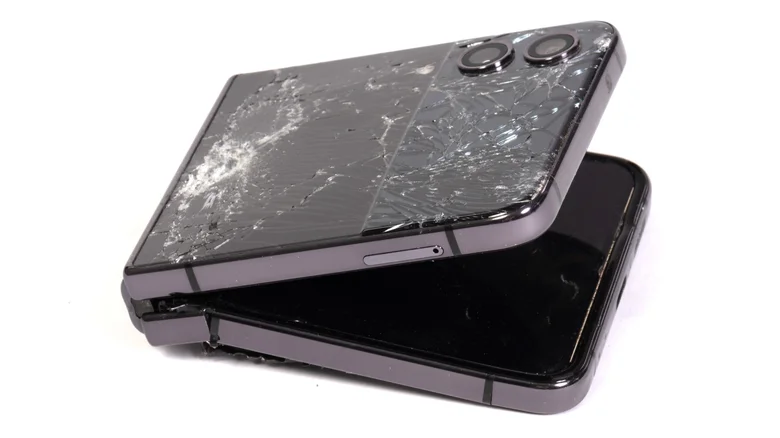 Shattered exterior screen and broken interior of a foldable phone.