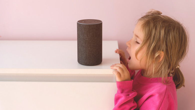 A little girl speaking to an Amazon Alexa.