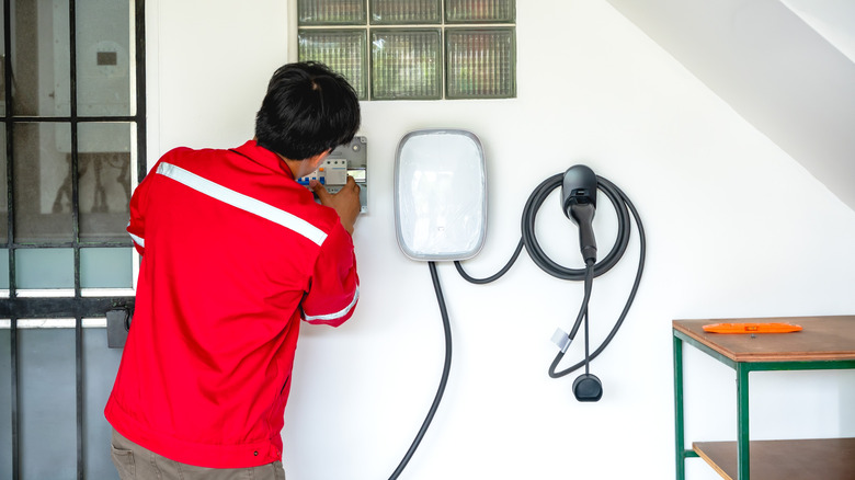 A technician installs a level 2 charger at a home