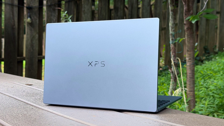 An XPS 13 on a backyard table.