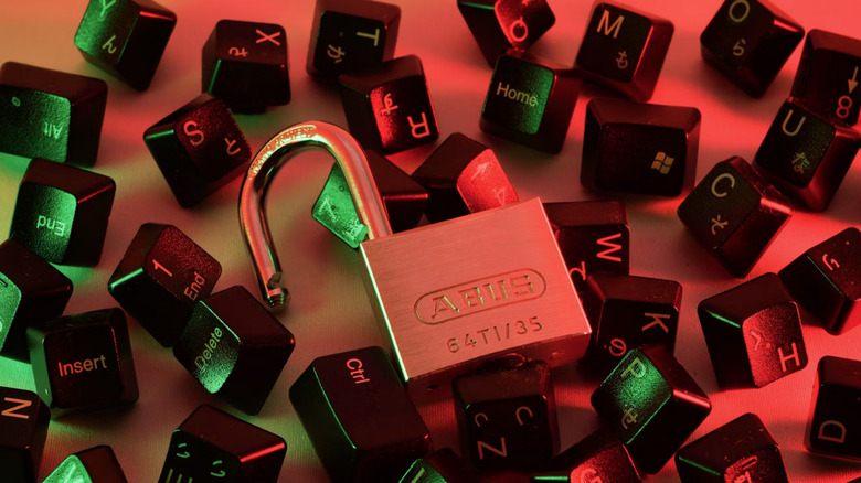 A lock over some broken keys from a computer.