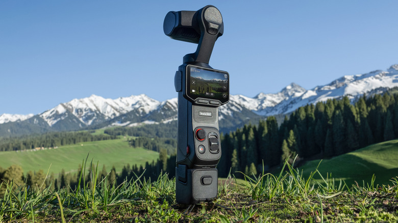 A Insta360 Luna Ultra camera sitting on some grass.