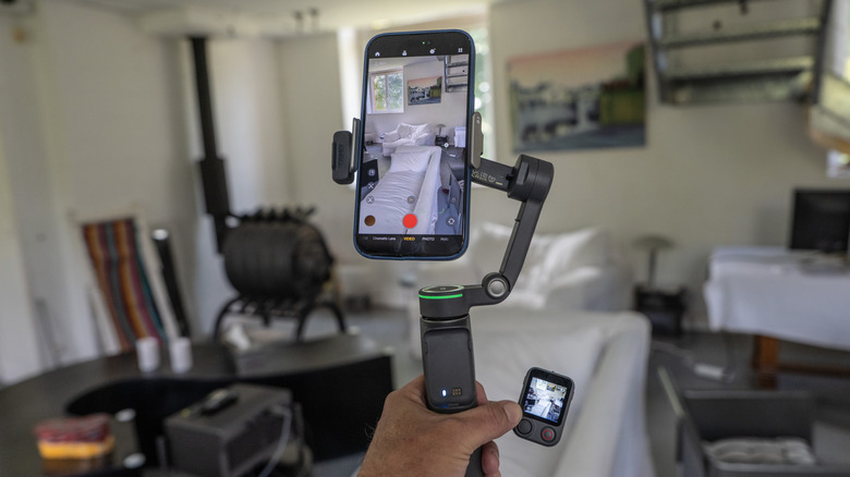 DJI's Osmo Mobile 8P gimbal with an iPhone 16 showing a remote at the bottom of the image