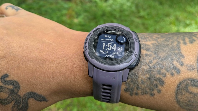 A tattooed right-hand/wrist with a Garmin Instinct 2 watch on