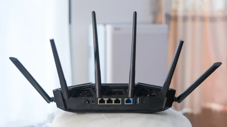 The rear of a gaming router, showing antennae along with Ethernet and USB ports.