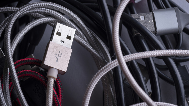 Assorted USB cables with a USB-A connector in the foreground.