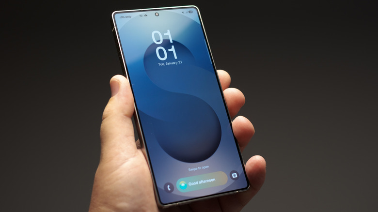 A Samsung Galaxy smartphone, being held up, with the lock screen visible.