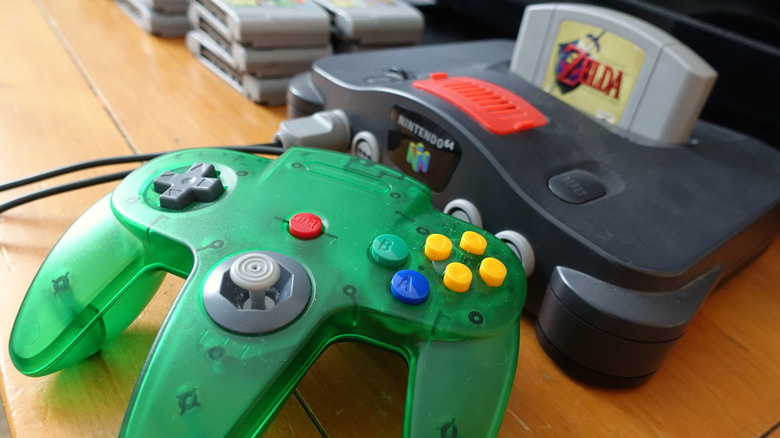 Close-up view of the Nintendo 64, game and green controller.