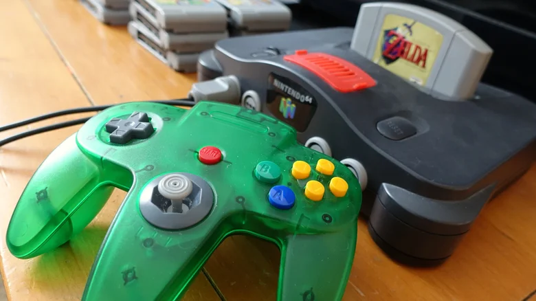 Close-up view of the Nintendo 64, game and green controller.