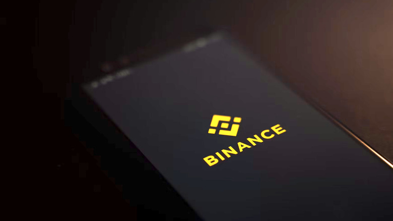 A Binance logo on a smartphone.