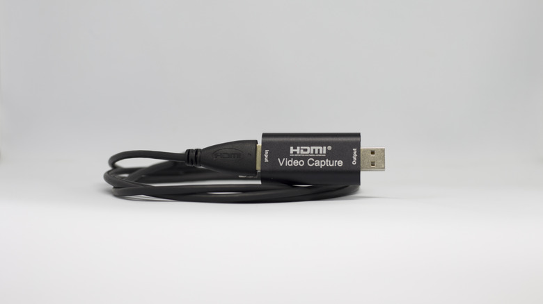 HDMI video capture adapter with a coiled cable.