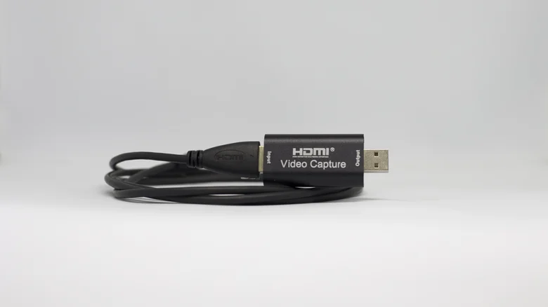 HDMI video capture adapter with a coiled cable.