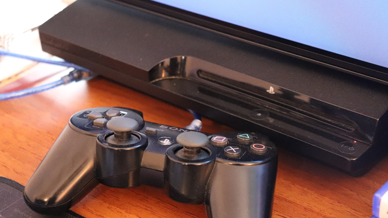 Dualshock 3 controller in front of Playstation 3.