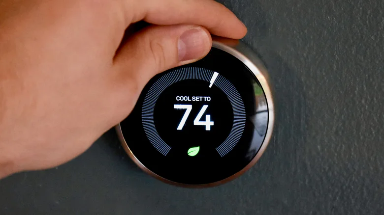 Spinning the temperature ring on an older Nest Thermostat.