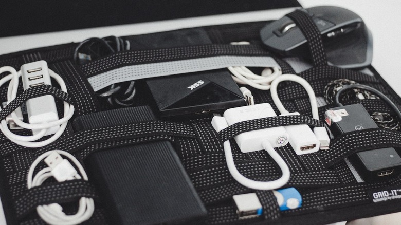 Black case filled with electronics and cords.