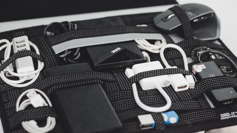 Black case filled with electronics and cords.