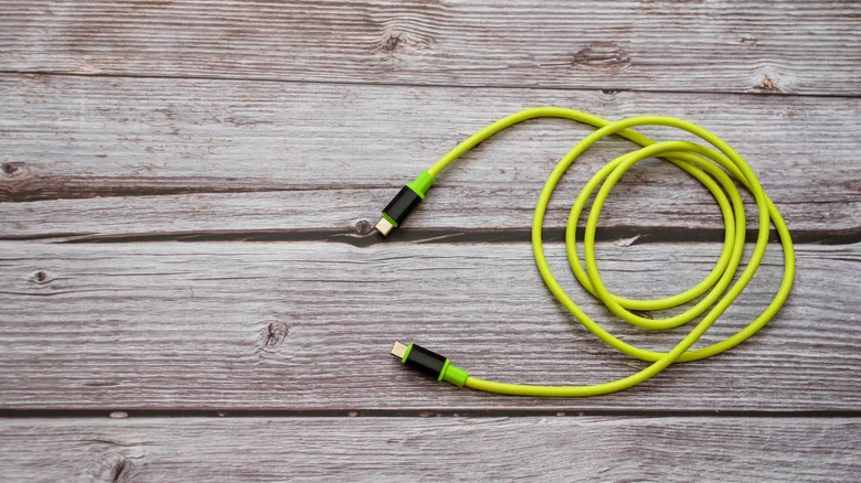 Green USB-C cable on table.
