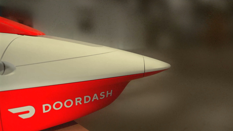 The nose of a drone with a DoorDash logo on the side.