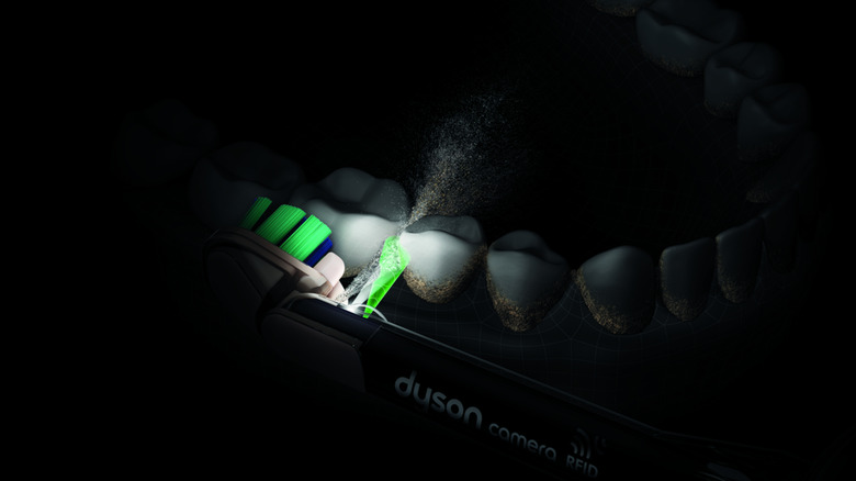 A close up of the Dyson CameraJet squirting water into the gap between teeth.