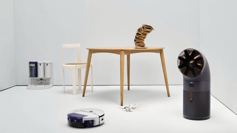 Dyson's new robot vacuum and air purifier series, with a pile of toast on a table.
