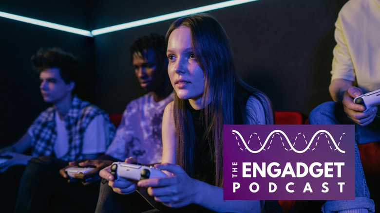 A teenaged girl playing video games on a couch with friends.