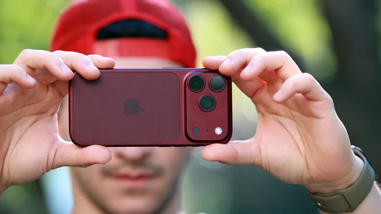 A person holding the iPhone 18 Pro to take a picture.