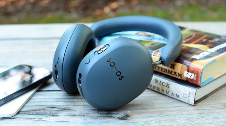 Sonos Ace Ultra headphones laying on a stack of books.