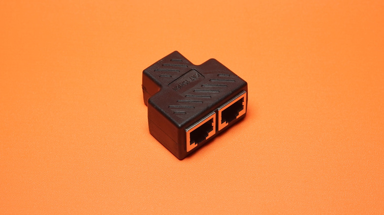 Passive Ethernet splitter against a plain background