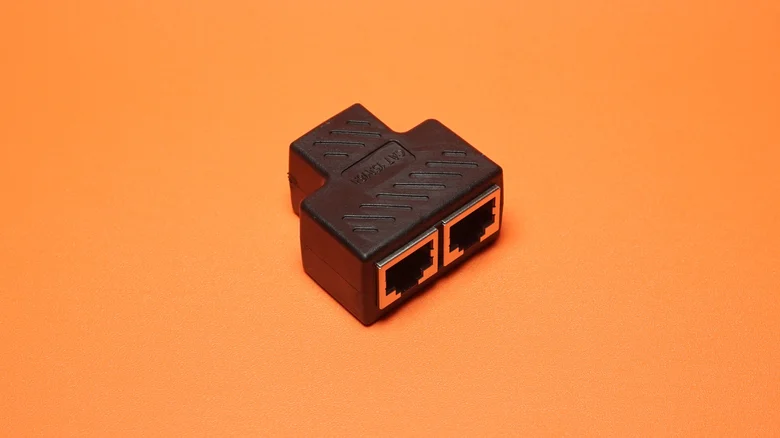 Passive Ethernet splitter against a plain background