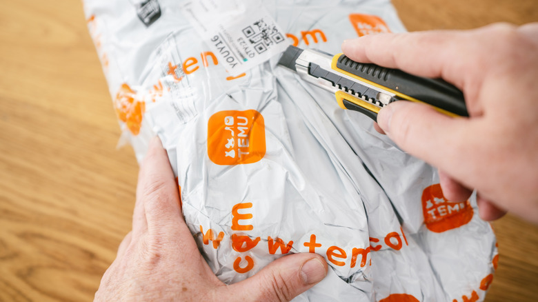An image shows someone opening a Temu package with a knife