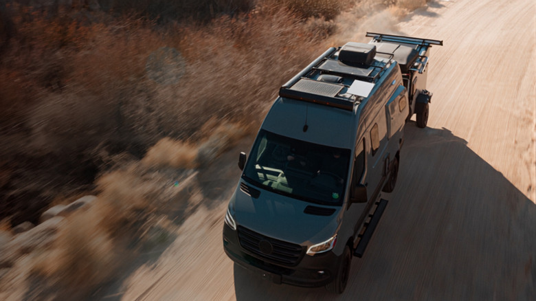 Aerial view of Starlink Mini mounted on top of a travel van that is driving down the road.