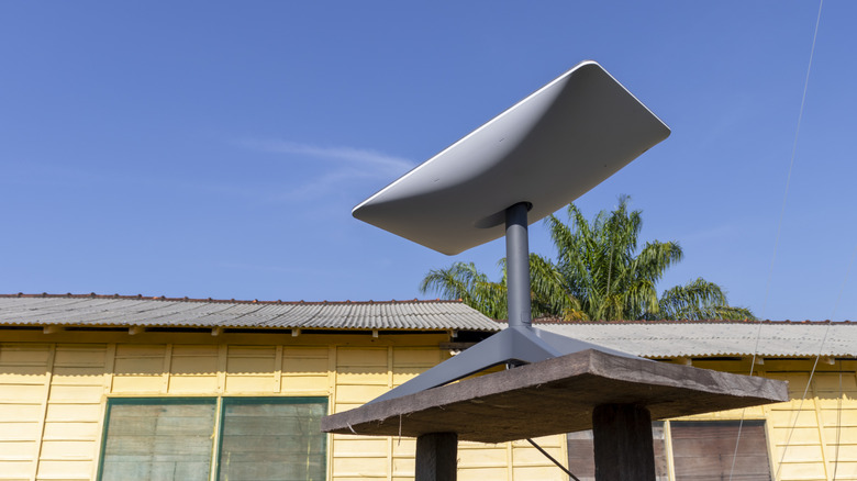 Starlink dish set up outside of a home.