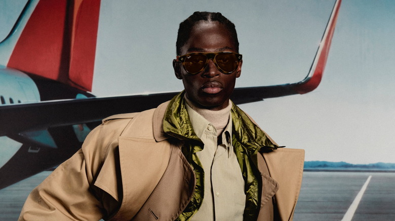 A person wearing Aviator-style smart glasses,