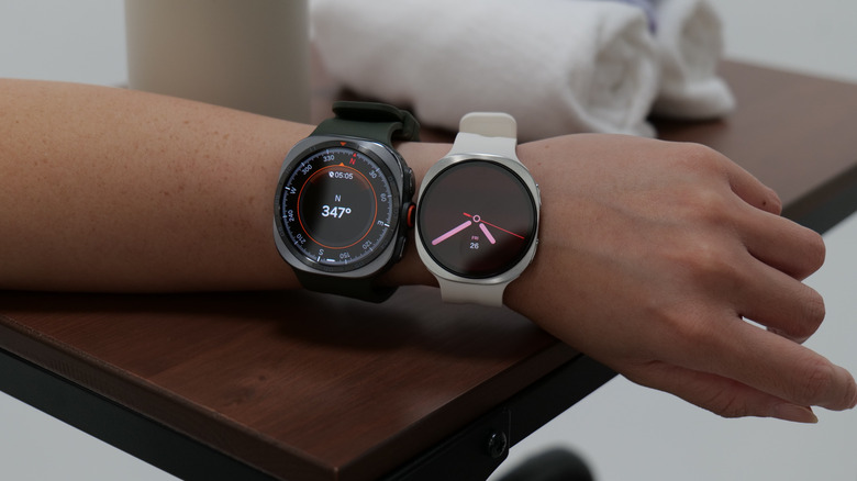 Two smartwatches on a person's wrist.