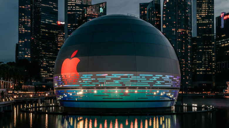 Apple logo on a sphere wit ha cityscape in the background