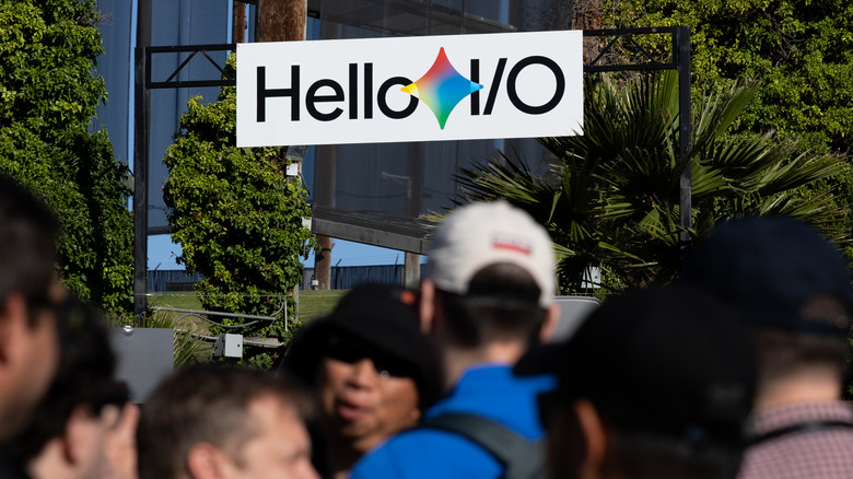 People milling below a sign that reads 
