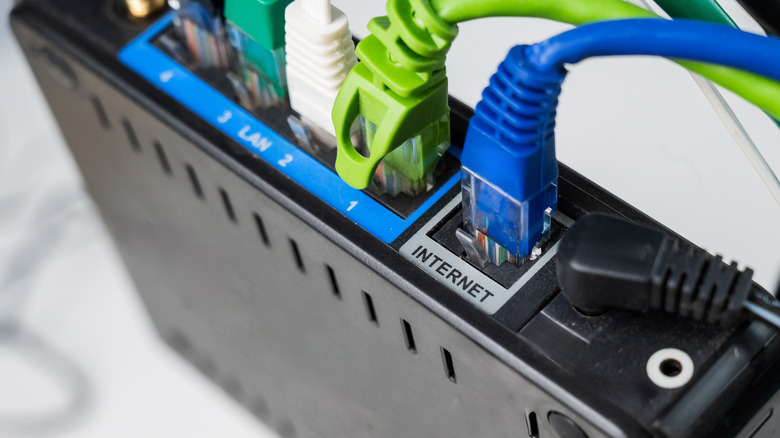 Colored Ethernet cables connected to LAN and internet ports on a router.