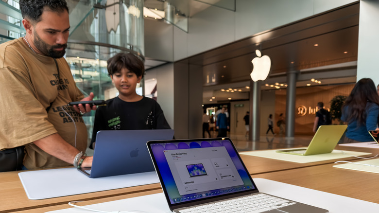 MacBook Neos on display at an Apple Store.