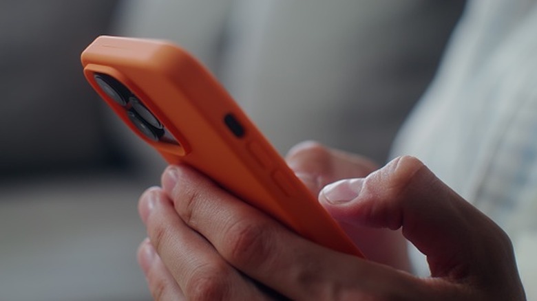 Person typing on the phone.